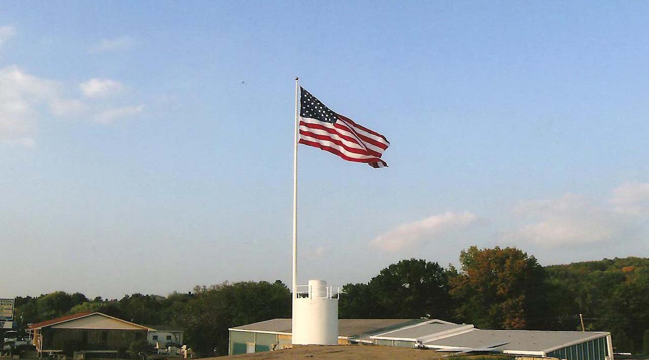 American Flag flying overtop of Hampton Concrete Products, Inc. main showroom